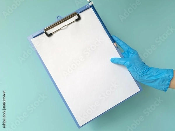 Obraz Hand in blue protective glove holding blank tablet