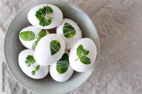Obraz Easter eggs Decorated with leaves on textile background. Concept for your design