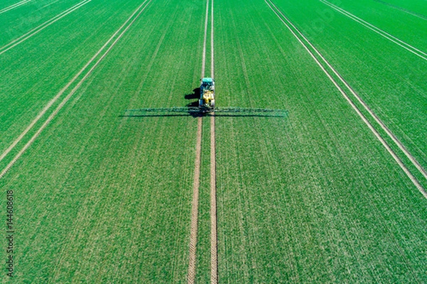 Fototapeta Spraying machine on the field