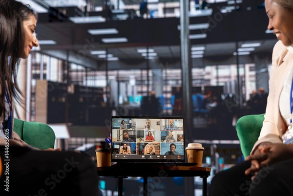 Obraz Multicultural team of women leaders hold an online conference call, showcasing collaboration and career growth in a professional, remote setting. Entrepreneurs discuss with investors group.