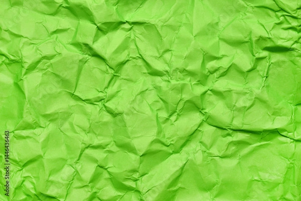 Obraz A textured green crumpled paper background with natural creases and folds. Ideal for design projects, digital graphics, or creative presentations requiring a vibrant, tactile surface element