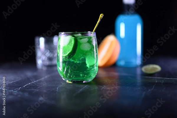 Obraz Mojito cocktail with lime wedges and ice on black background
