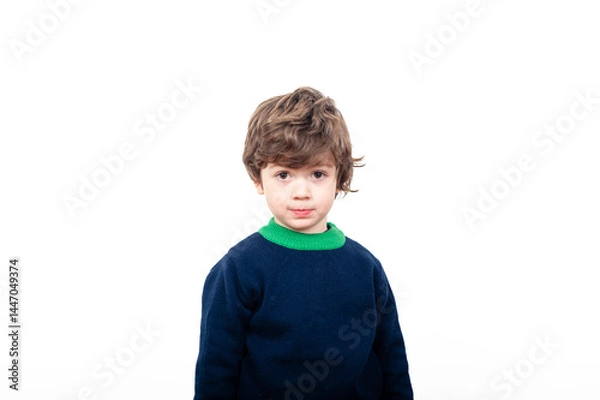 Fototapeta Curly-haired boy poses on white background