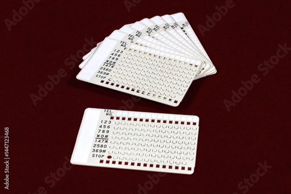 Obraz Vintage autodial punchcards for 1970s touchtone telephone. Numbers were programmed by punching out the appropriate number on the card. 

