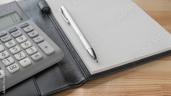 Fototapeta calculator , pen and  notebook on the desk