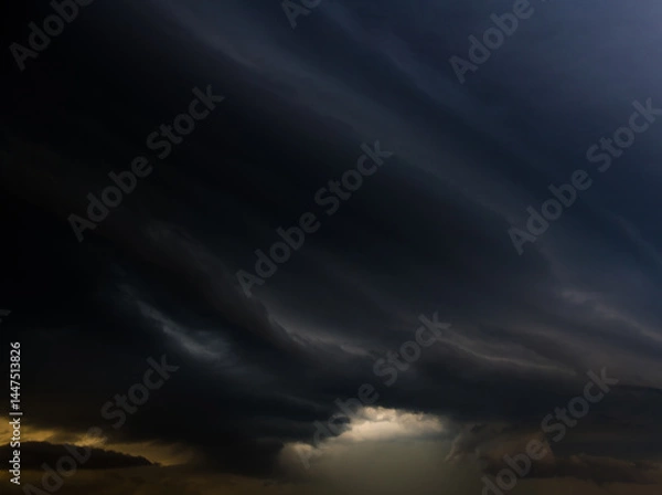 Obraz Large black clouds in the sunset sky before the rain