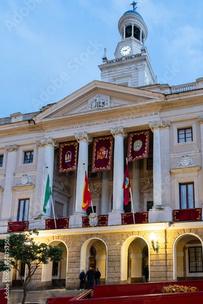 Fototapeta Cadiz, Spain - April 16, 2025: Cadiz Town Hall, with the surrounding streets lined with fences for the Holy Week processions in Cadiz, Spain