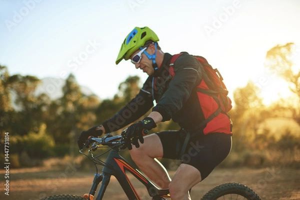 Fototapeta Bike, dirt road and sports with man in mountains for outdoor adrenaline, adventure or training. Exercise, fitness and helmet with person cycling in nature for challenge, competition or performance