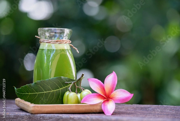 Obraz Neem leaves and extract with water on natural background.