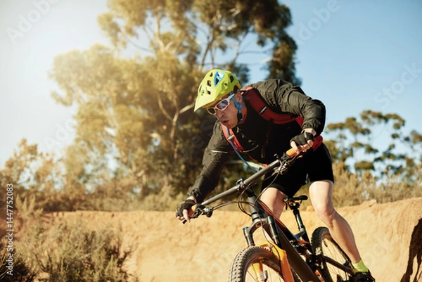 Fototapeta Bike, speed and sports with man in mountains for outdoor adrenaline, adventure or training. Exercise, fitness and trail riding with person cycling off road for challenge, competition or performance