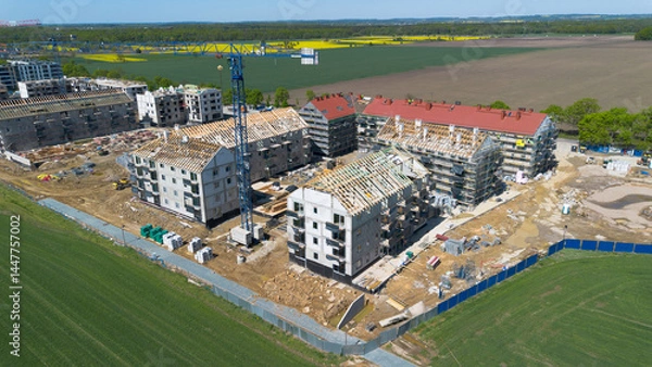 Obraz Aerial view of a residential construction site with cranes and unfinished buildings