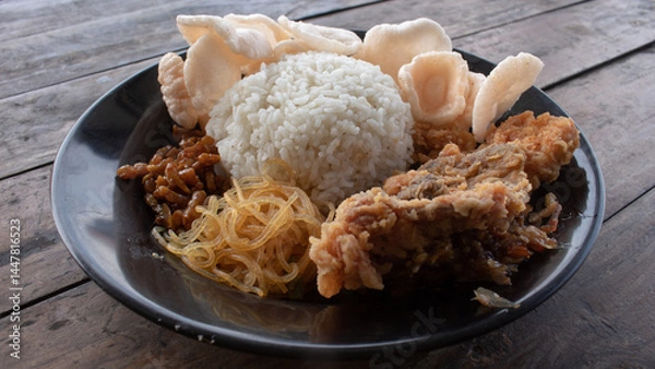 Fototapeta Spicy Crushed Fried Chicken with Rice – Indonesian Ayam Geprek