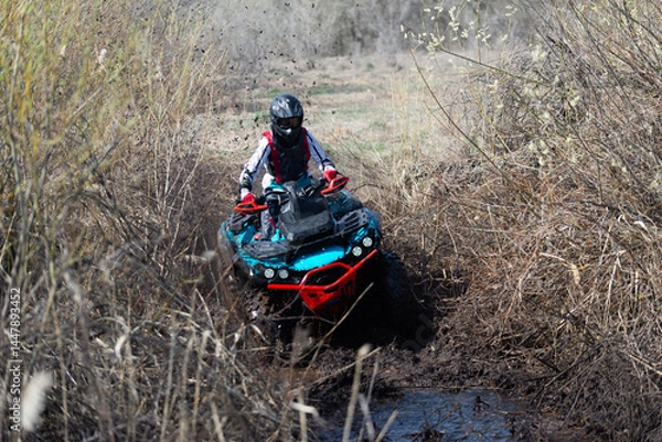 Obraz The ATV overcomes an impassable section of the road.
