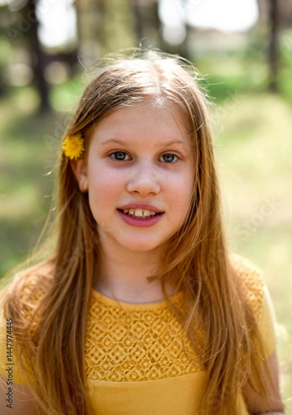 Fototapeta Portrait of a smiling pre-teen girl outdoors
