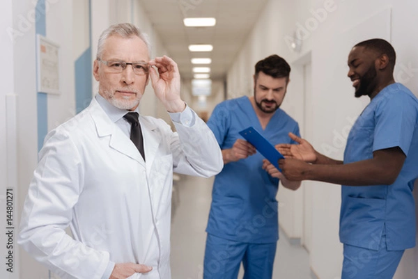 Obraz Charismatic aging medic demonstrating confidence at work