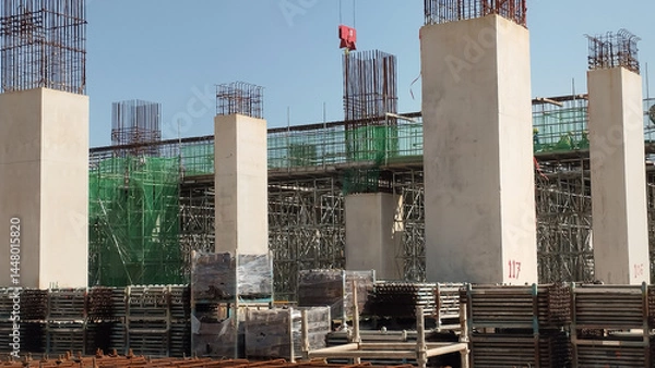 Obraz construction site with tower crane and reinforced concrete columns on-going construction