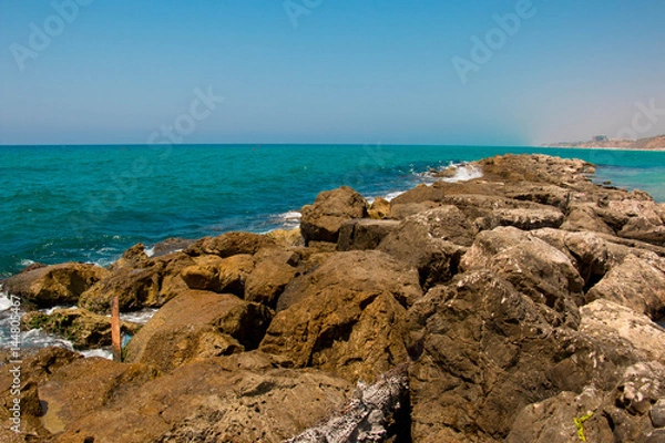 Fototapeta Beautiful seashore with breakwater and large stones