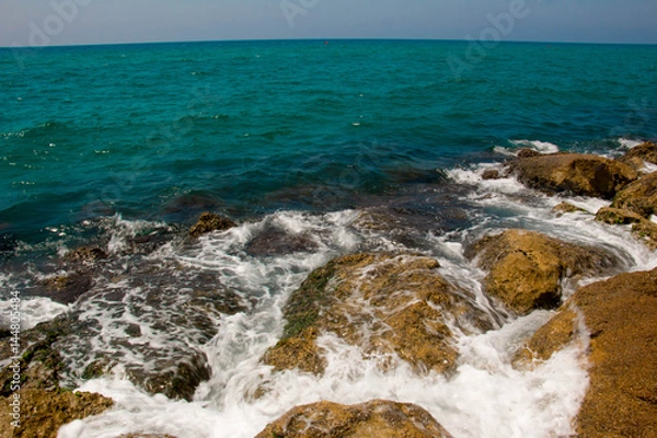 Fototapeta Beautiful seashore with breakwater and large stones