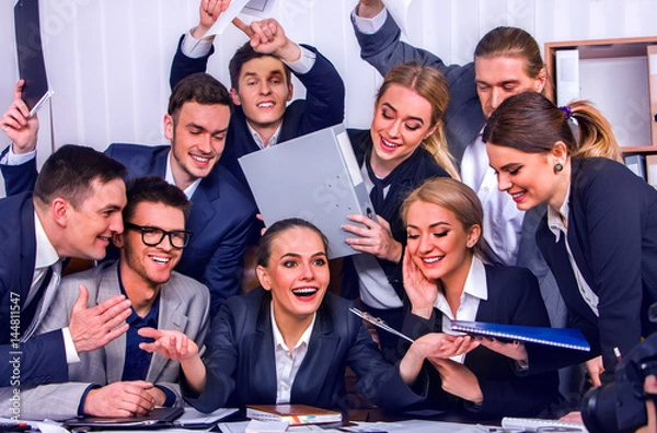 Fototapeta Business people office life of team people are happy with hand up sitting table and working papers . Cabinets with folders and jalousie background.