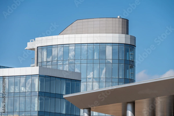 Fototapeta Geometric lines of architecture of modern building on the background of blue sky.