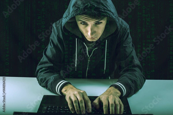 Fototapeta hacker in the dark breaks the access to steal information