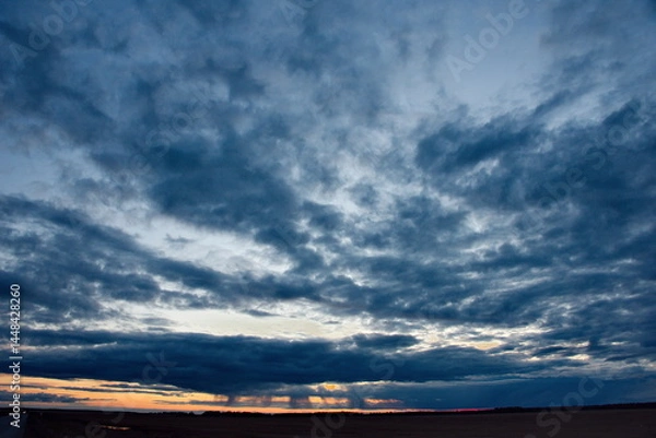 Fototapeta Central Kazakhstan. An unusually gloomy dramatic sunset with dark clouds.