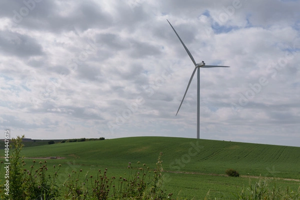 Obraz Wind turbine that rises in the green hill, generating clean electricity. Renewable energy