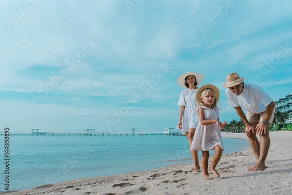 Obraz happy family father, mother and children on beach at sea. family on sandy beach near sea. travel, walking on a beach with adorable child on vacation or holiday at the ocean. joy of outdoor activities.