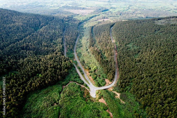 Fototapeta  Aerial view of The Vee Pass winding through the Knockmealdown Mountains, showcasing stunning Irish landscape, vibrant greenery, and dramatic elevation in County Tipperary, Ireland.