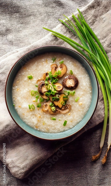 Fototapeta Savory breakfast bowl featuring creamy congee elegantly arranged with mushrooms and fresh green onions