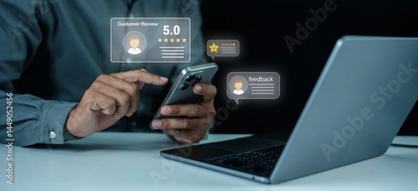 Fototapeta A person uses a smartphone and laptop to leave and read digital customer reviews and feedback online.