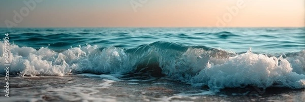 Obraz Foamy ocean waves crashing on a sandy shore at sunset. Possible use Nature photography, travel brochures, digital wallpaper