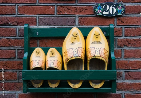 Obraz Storage rack with clogs next to frontdoor