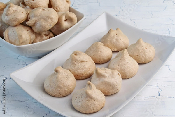 Obraz Meringues on crockery plate and light background