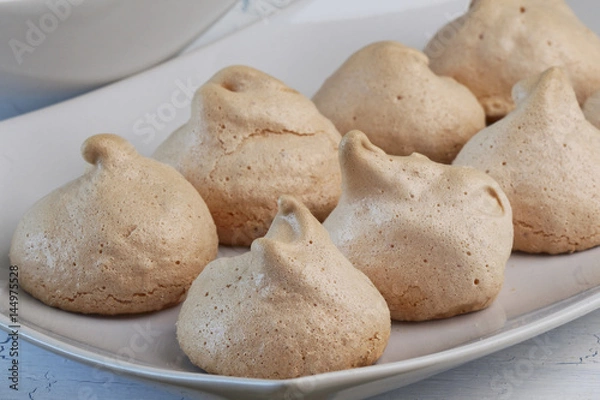 Obraz Meringues on white plate and light background