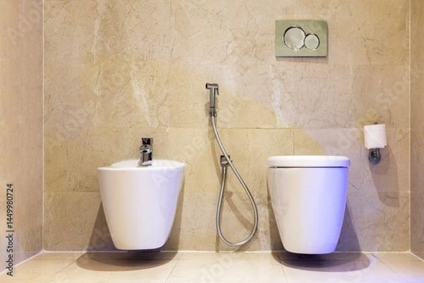 Obraz  modern white toilet bowl and white wall-hung bidet in bathroom.