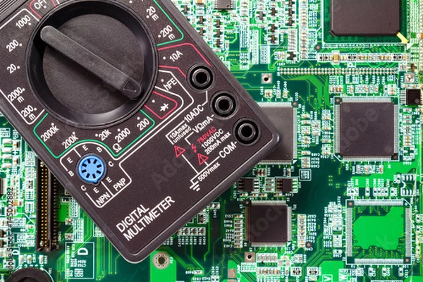 Obraz Fragment of a digital multimeter closeup on a printed circuit board
