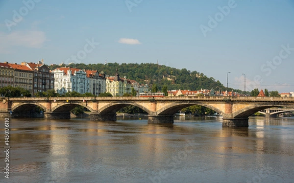 Fototapeta Historic bridge in Prague with red trams
