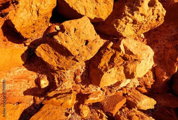 Obraz Iron ore, background, texture. Stone close-up. Ferrous metal ore. Iron ore mining, Hematite (Fe2O3) held. Relief of earth after excavations in open pit. Extraction of minerals and minerals in quarry