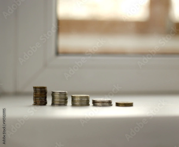 Obraz Coins are stacked in a row