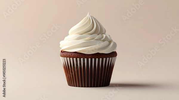 Fototapeta A single chocolate cupcake with a tall swirl of white frosting sits in a brown and white striped paper liner against a light brown background.