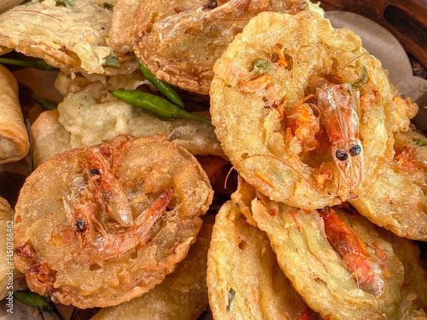 Obraz Gorengan fried Bakwan udang on a plate served with green chili peppers is traditional authentic typical snack from Java.