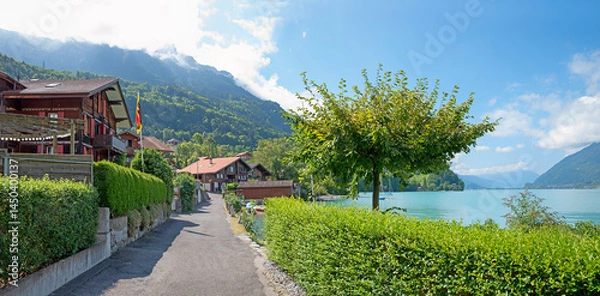 Fototapeta lakeside walkway Iseltwald with hedges and chalets, tourist resort lake Brienzersee.