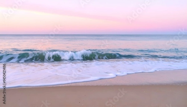 Obraz Serene pastel sunset over ocean waves gently lapping on sandy beach. Perfect for calming backgrounds or travel publications.