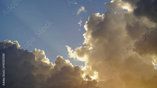 Fototapeta Golden sunset sky background, golden clouds, evening with the sun setting.