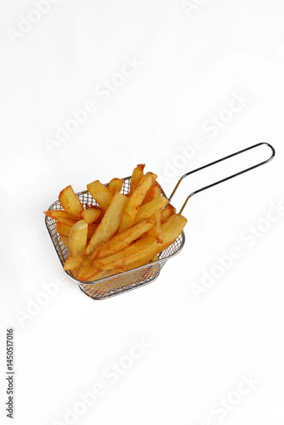 Obraz Homemade fries cooked and placed in a small individual metal basket on a white background, crisp and tasty presentation