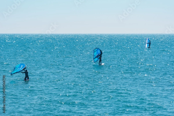 Obraz Windsurfers on the sea surface at morning.