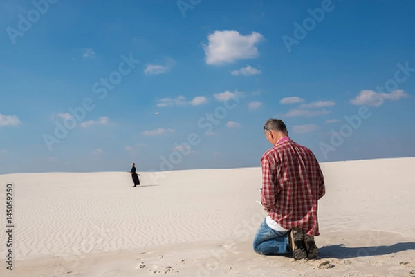 Fototapeta Man with the help of a drone shoots a film about martial arts