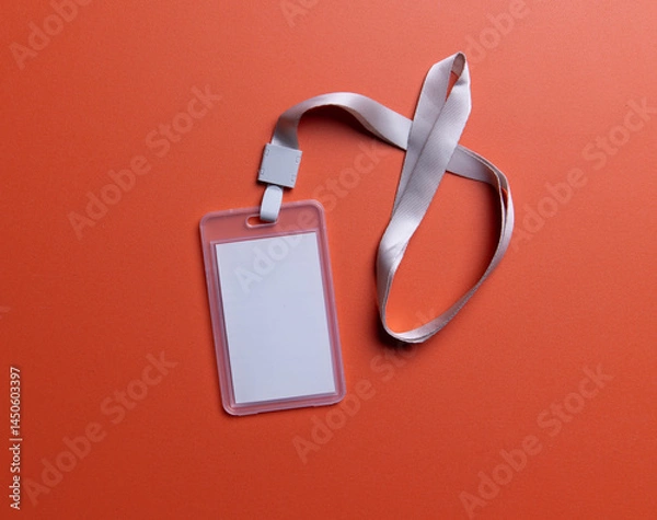 Fototapeta Mockup of a blank white ID card with a white lanyard on orange background