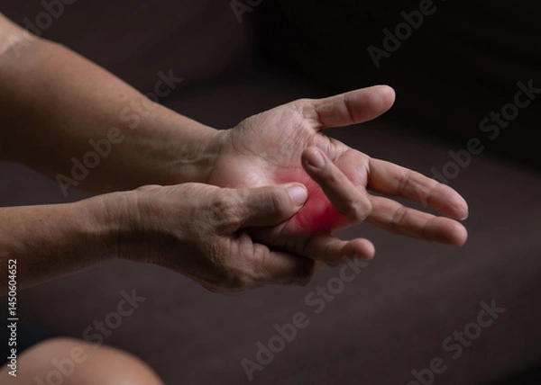 Fototapeta Trigger Finger, Senior woman's left hand massaging her ring finger, Suffering from pain, Close up and macro shot, Health care concept